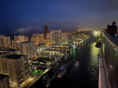 a view of a city at night with a river at Dream Beach Apt 1BR Kitchen & Pool Access 06A in Hallandale Beach