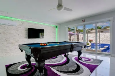 a pool table in a living room with a tv at Hollywood Home w Pool Jacuzzi BBQ and Pool Table in Hollywood
