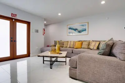 a living room with a couch and a table at Hollywood Home w Pool Jacuzzi BBQ and Pool Table in Hollywood