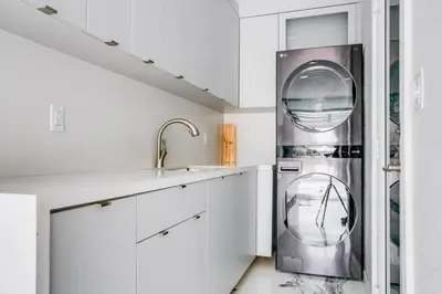a kitchen with white cabinets and a stainless steel dishwasher at Hollywood Home w Pool Jacuzzi BBQ and Pool Table in Hollywood