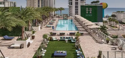 an outdoor swimming pool with chairs and umbrellas at Lux apartment Hyde Beach House in Hollywood
