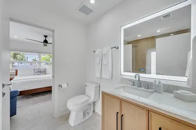 a white bathroom with a toilet and a sink at 180 of Waterfront Heated Pool Walk To Beach Paradise Point Key RESIDENCES in Fort Lauderdale