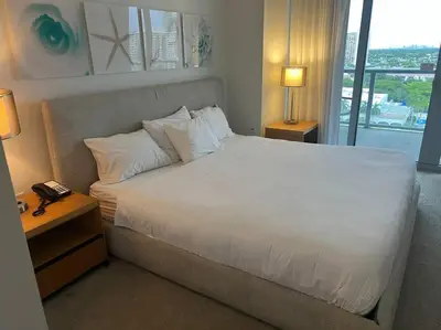a bedroom with a large white bed and a window at Cozy & Comfortable 1BR Apt in Miami Beach 2804A in Hallandale Beach