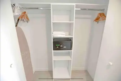 a walk in closet with white shelves and a appliance at Cozy & Comfortable 1BR Apt in Miami Beach 2804A in Hallandale Beach