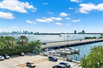 a marina with cars parked next to the water at Bella Vista - Water views Pool and Parking in Miami Beach