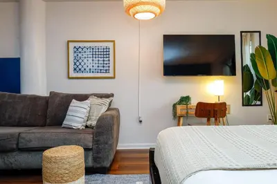 a living room with a couch and a tv at Bella Vista - Water views Pool and Parking in Miami Beach