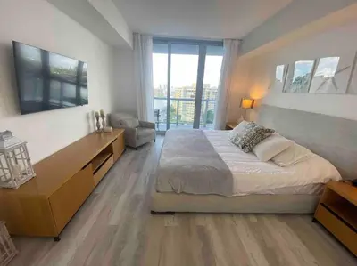 a bedroom with a large bed and a large window at Miami Beach 1 Bedroom w Pool 1109A in Hallandale Beach