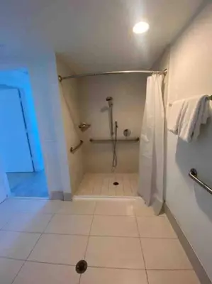 a bathroom with a shower and a tiled floor at Miami Beach 1 Bedroom w Pool 1109A in Hallandale Beach