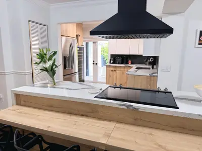 a kitchen with a large island in the middle at Amazing 3-bedroom modern home in Coral Gables area in Miami