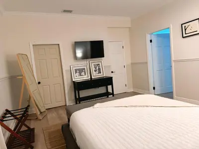 a bedroom with a bed and a flat screen tv at Amazing 3-bedroom modern home in Coral Gables area in Miami