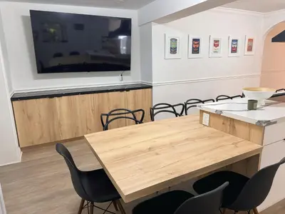 a conference room with a wooden table and chairs at Amazing 3-bedroom modern home in Coral Gables area in Miami