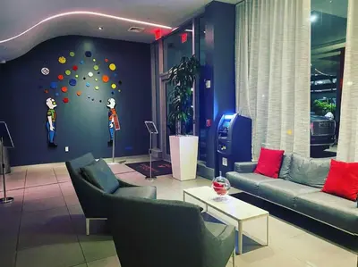 a living room with couches and a wall with a ball wall at Miami Beach Luxury Apt, Ocean Views, Full Kitchen -A in Hallandale Beach
