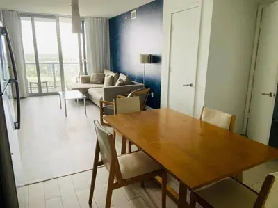 a living room with a table and a couch at Miami Beach Luxury Apt, Ocean Views, Full Kitchen -A in Hallandale Beach