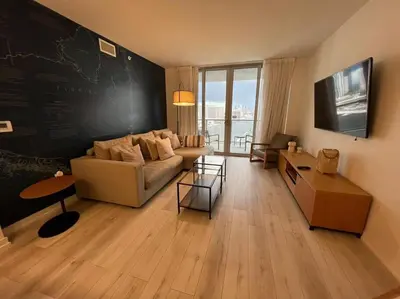 a living room with a couch and a chalkboard wall at Boutique-Style Retreat, Miami Views & Full Amenities -A in Hallandale Beach