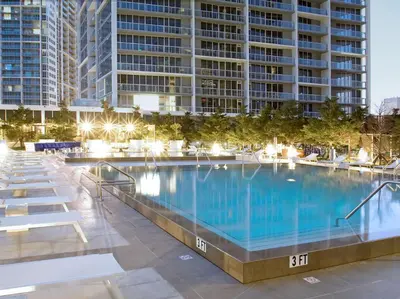 a large swimming pool in front of a tall building at Wonderful 2 BR Condo Icon Brickell With Pool in Miami