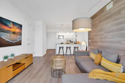 a living room with a couch and a kitchen at Modern Resort with Balcony - Pool - Gym in Hallandale Beach
