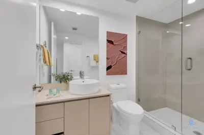 a bathroom with a sink and a toilet and a shower at Modern Resort with Balcony - Pool - Gym in Hallandale Beach