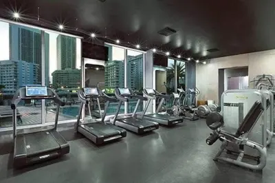 a gym with treadmills and ellipticals in a building at Modern Beach Studio, 2 Full Beds, Prime Location in Hallandale Beach