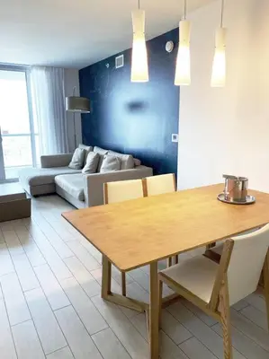 a living room with a table and a couch at Elegance in Miami Beach, Kitchen & Views -A in Hallandale Beach