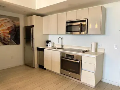 a kitchen with a sink and a microwave at Elegance in Miami Beach, Kitchen & Views -A in Hallandale Beach