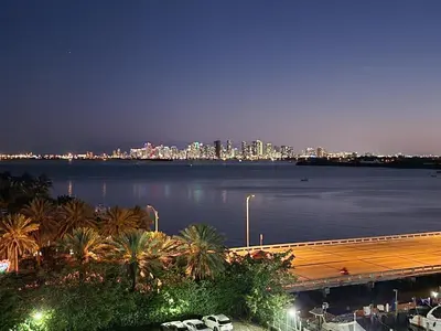 a view of a city from the water at night at Bayfront Apartment Breathtaking Views- one bedroom w balcony- living room -Free Parking in Miami Beach