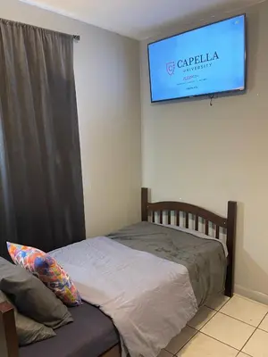 a bedroom with a bed and a tv on the wall at Best Value inside City Miami, Near Airport, Beach, Center & Metro in Miami